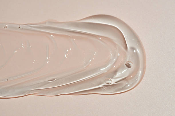 istock Glycerin gel texture smear. Transparent serum swatch on beige background. Liquid gel moisturizer with bubbles macro 2157446926