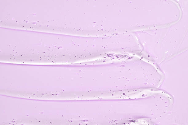 istock Gel serum texture. pink liquid skincare background. Transparent beauty product with bubbles closeup 2157446963