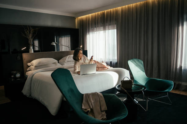 Business woman using laptop in hotel room