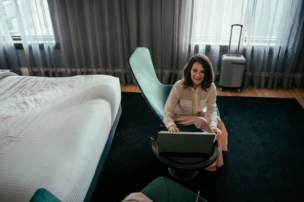 istock Business woman using laptop in hotel room 2157447499