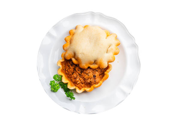 pork and ham pie with eggs on a wooden board