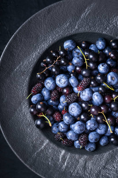 istock Top view of fresh blueberries, blackcurrant berries and mulberries 2157451521