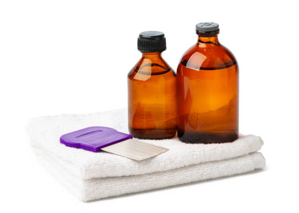 Comb, anti lice medicine and towel on white background close up