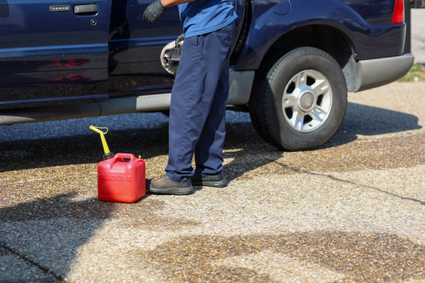 Jerrycan and petrol station worker with a refuel gun isolated on white background