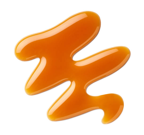 istock Caramel sauce swirl on white background 2157456549