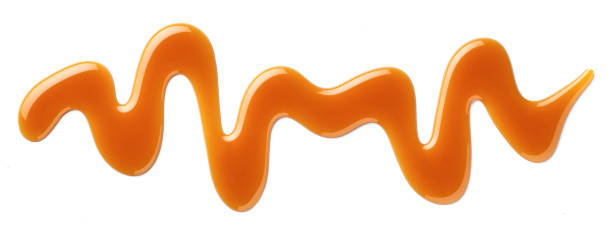 istock Caramel sauce swirl on white background 2157456564