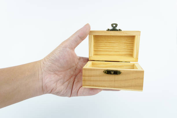 istock hand holding small wooden box on white background. 2157458810