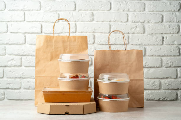 istock Take out food in boxes and craft bag against brick background 2157458963