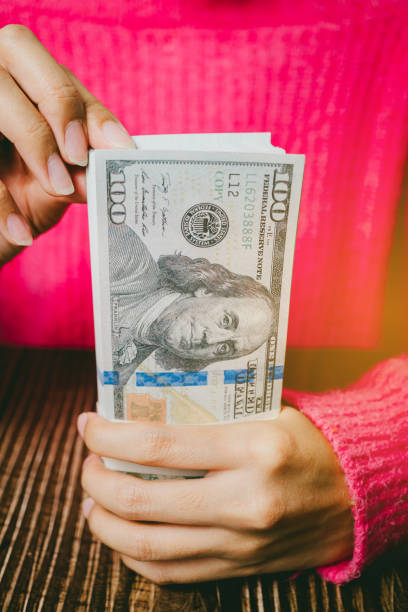 istock Female hands holding banknotes, finance concept 2157459747