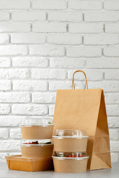 istock Take out food in boxes and craft bag against brick background 2157460600