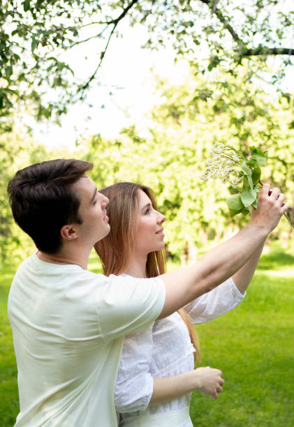 young couple on a picnic in summer park
