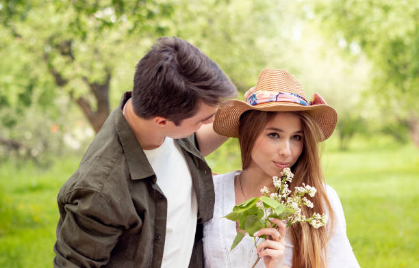 young couple on a picnic in summer park