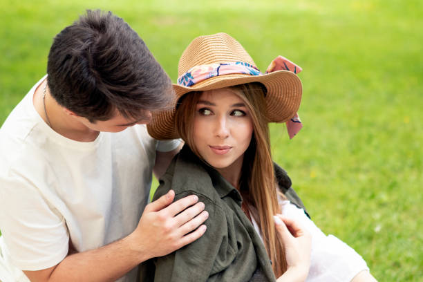young couple on a picnic in summer park