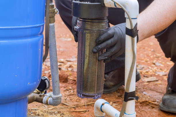istock Worker performs maintenance on a residential water line filter in domestic water treatment facility 2157464697
