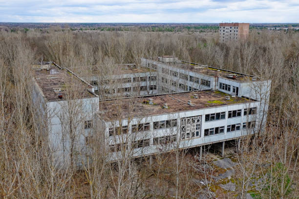 istock Decaying architecture amidst barren trees, evidence of neglect. 2157467425