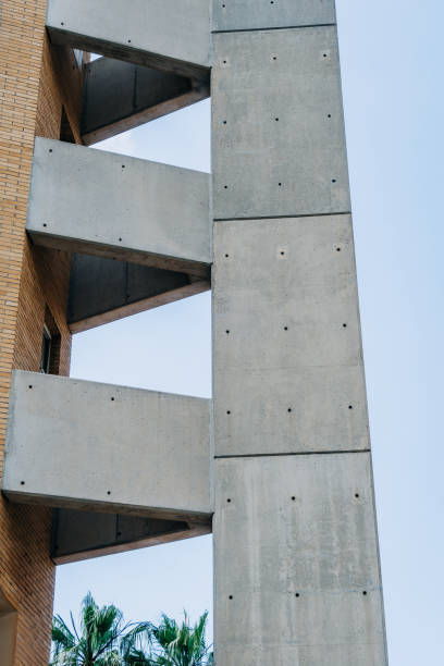 istock Imposing Brutalist Architecture Building Under a Clear Blue Sky. This is a classic example of brutalist architecture, characterized by its raw concrete structure and repetitive geometric shapes 2157470307