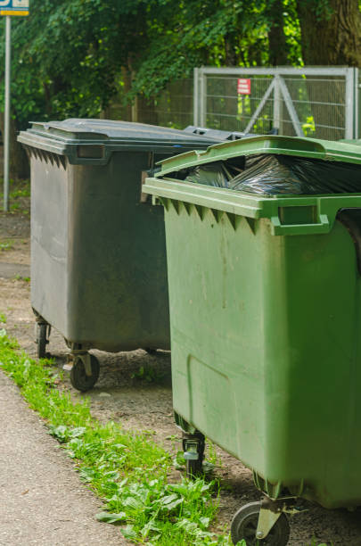 istock Two Green plastic trash recycling containers.Green containers for collecting garbage on the dustbin. 2157472153