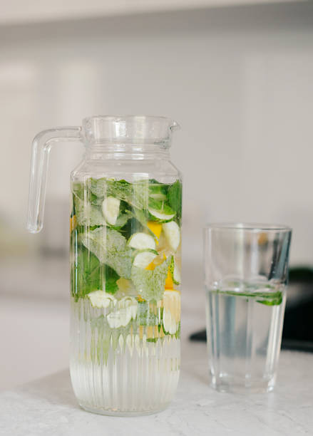 istock diet water. Cucumber, lemon, mint lemonade in glasses 2157474575