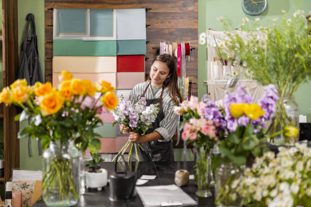 istock Young Florist Cutting Flowers 2157474625