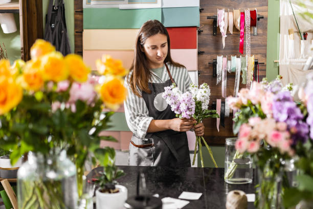 istock Young Florist Cutting Flowers with Joy 2157474655