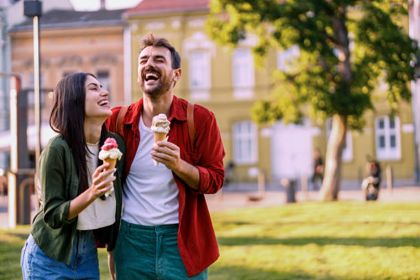 istock Couple laughing and holding ice creams 2157475208