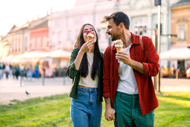 istock Couple sharing ice cream outdoors in city 2157475246