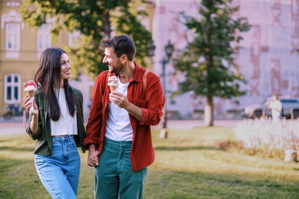 istock Intimate couple walking with ice creams 2157475261
