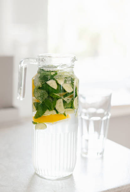 istock diet water. Cucumber, lemon, mint lemonade in glasses 2157475286