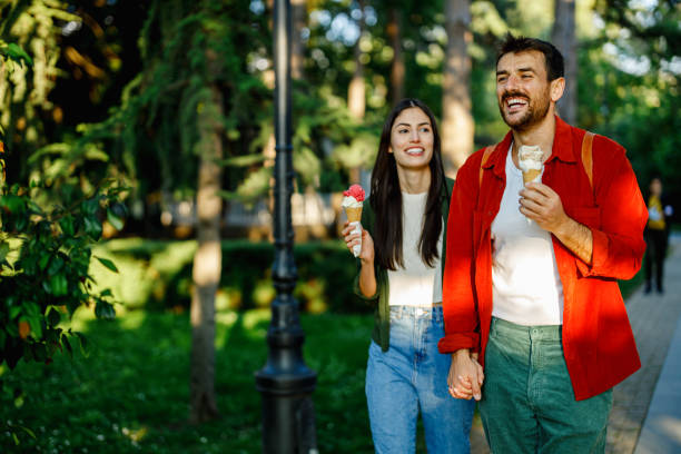 istock Smiling couple with ice cream enjoying a walk 2157475325