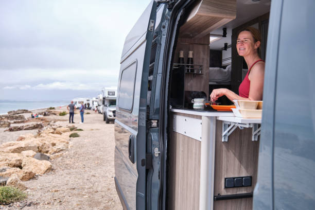 istock A Woman cooking in the camper van while traveling 2157475335