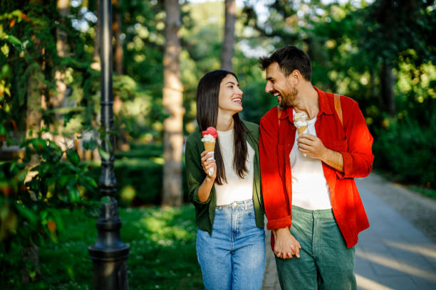 istock Couple sharing ice cream and a laugh outdoors 2157475355