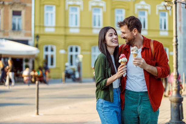 istock Couple laughing holding ice cream cones 2157475420