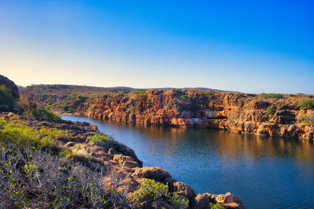 Gorge with red limestone rocks and outback vegetation, Cape Range National Park, Western Australia