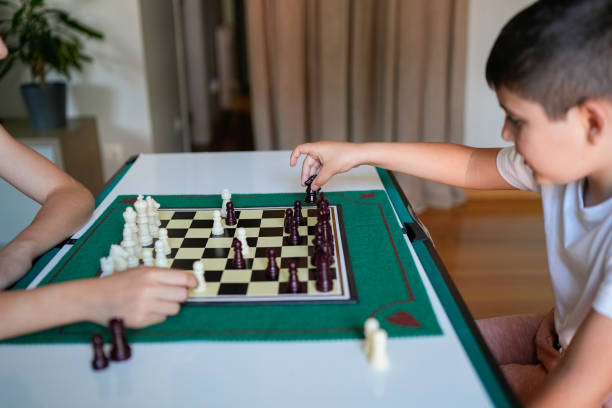 istock Two children playing a game of chess 2157478008