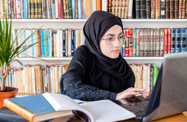 istock Arabic muslim woman using laptop for online meetings and studying 2157479021