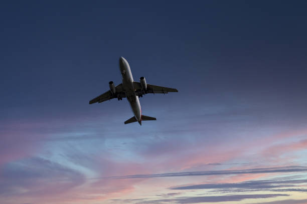 istock Holiday jet in flight isolated against a colourful dusk sky 2157481571