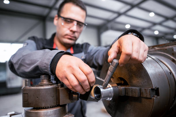 istock Industrial worker works on a metalworking machine 2157481798