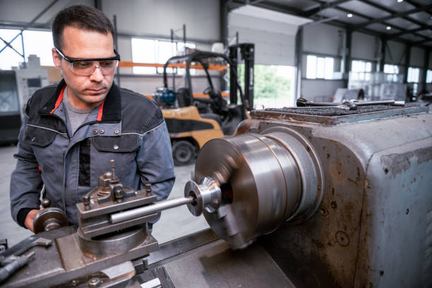 istock Industrial worker works on a metalworking machine 2157481799