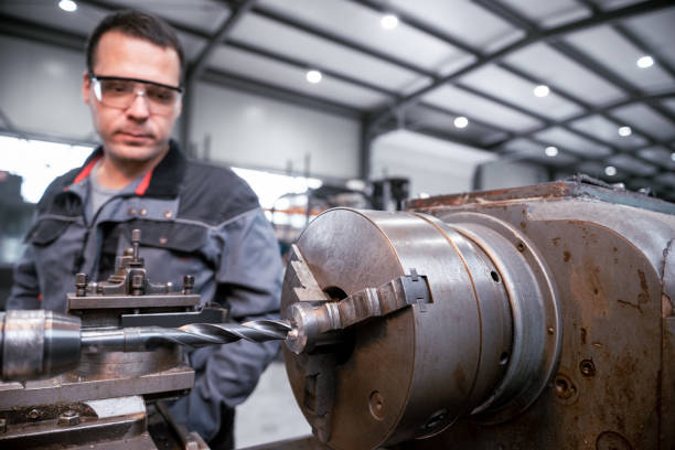 istock Industrial worker works on a metalworking machine 2157481800