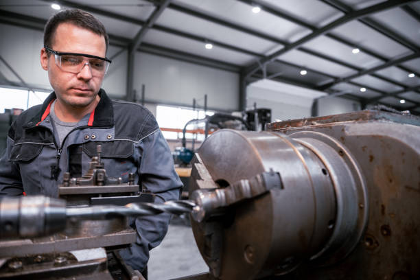 istock Industrial worker works on a metalworking machine 2157481801
