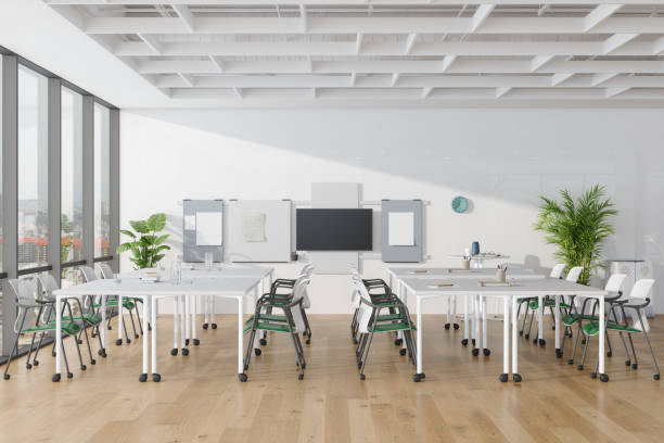 Empty Seminar Class With Tables, Chairs, Whiteboard And Potted Plants