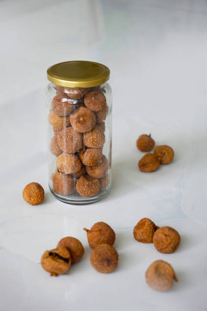 istock Dried lychees in a glass jar on a white marble background 2157482322