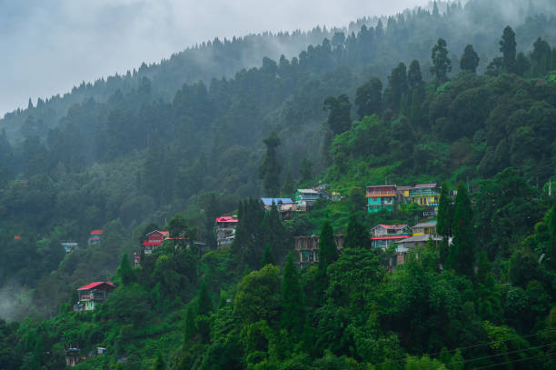 istock Monsoon clouds passing over Himalayan mountains of Darjeeling, West Bengal, India. Darjeeling is queen of hills and very scenic with beautiful green hills in rainy season. 2157482562