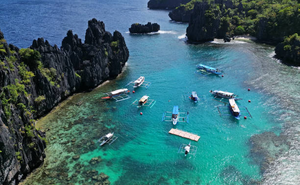 istock Tropical island with boats in lagoons 2157486330