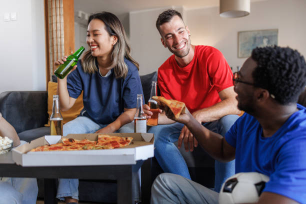 istock Soccer fans enjoying a game together 2157486468
