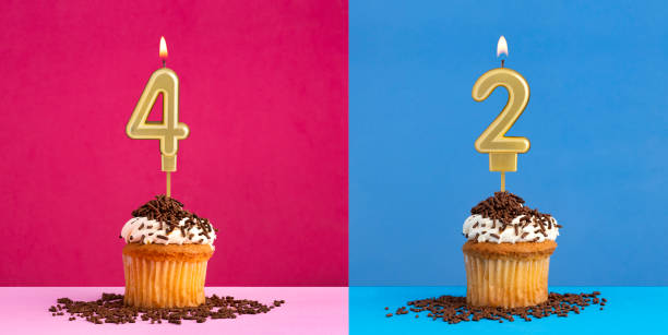 istock Two birthday cupcakes with the number 4 and 2 - Blue and pink background 2157489167