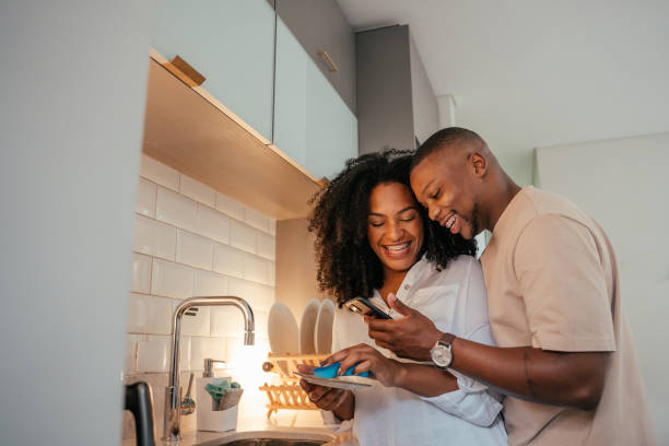 Young couple looking at smartphone at home