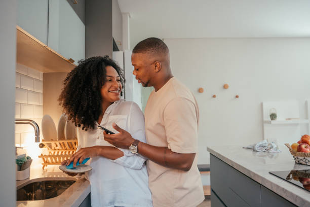 istock Young couple looking at smartphone at home 2157490075