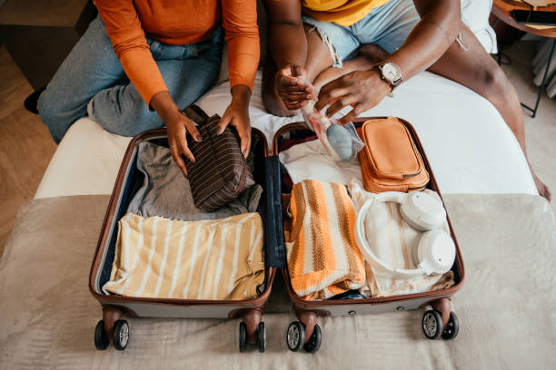 Couple packing for vacation trip