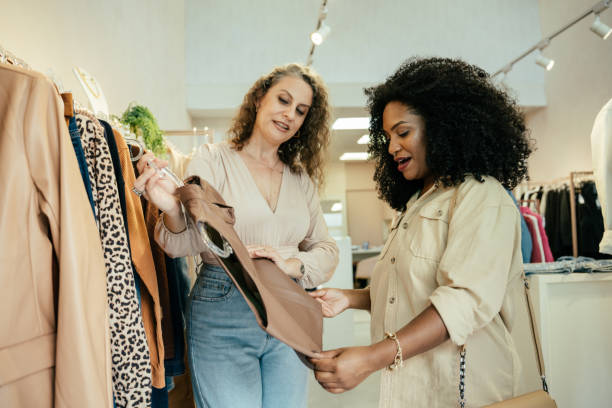 istock Black woman looking at clothes in a store 2157490846